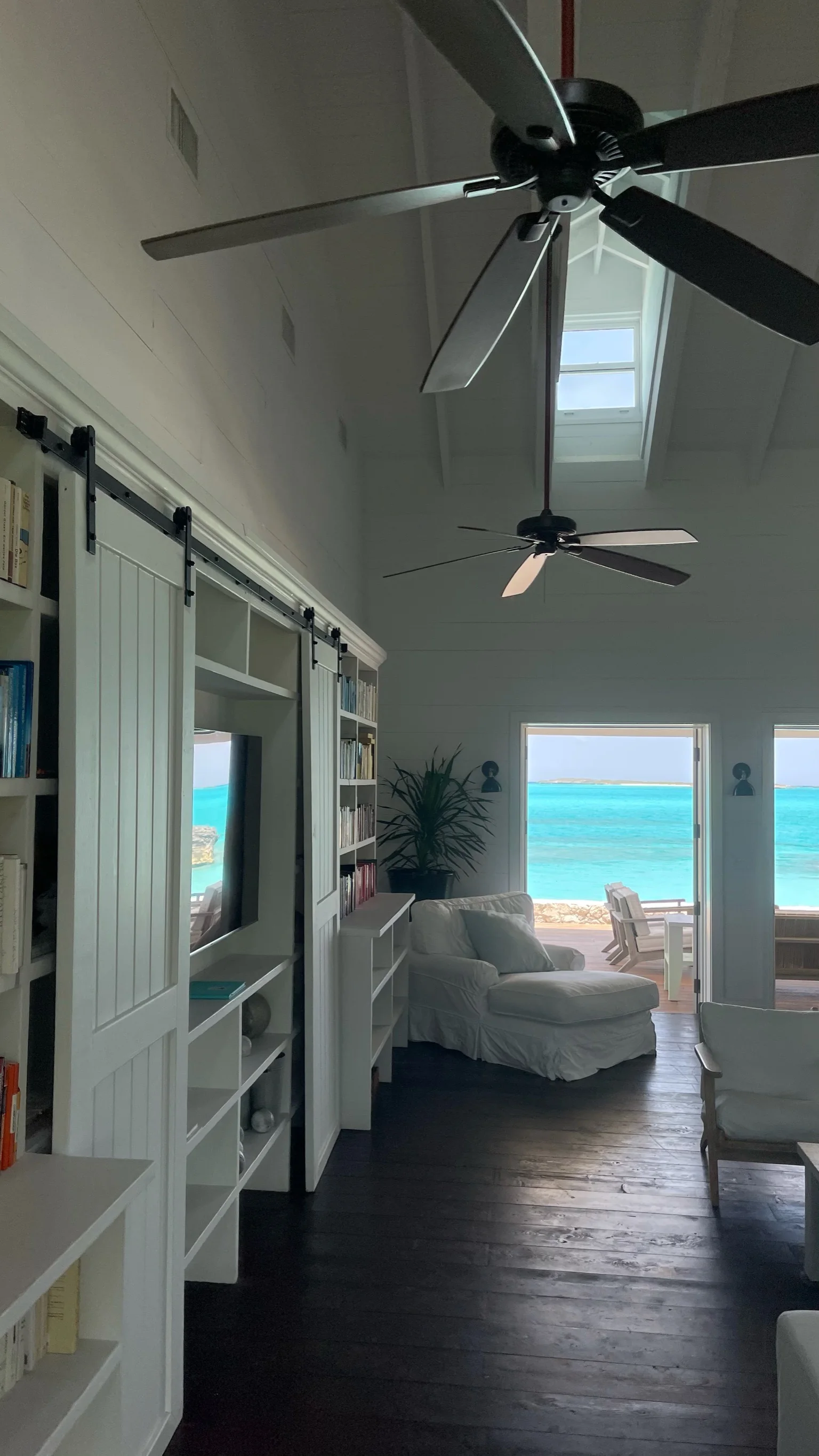 Coastal bedroom interior with ceiling fan